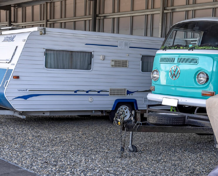 Caravan and Volkswagen Kombi in undercover storage